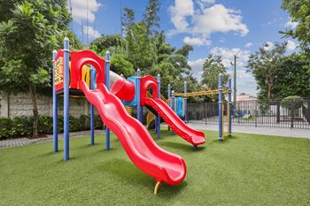 A playground with slides at Bay Village 1 Apartment in Palmetto Bay, FL